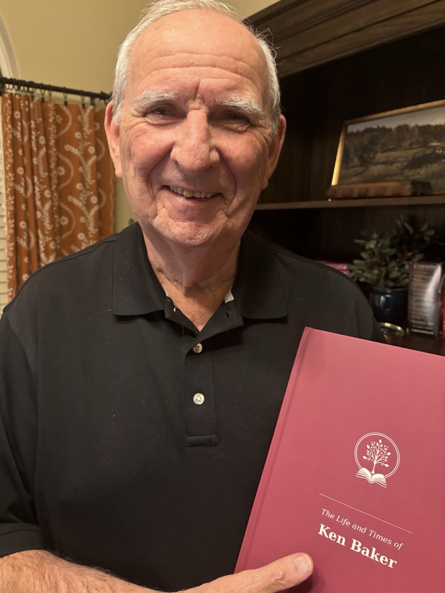 Ken Baker, founder of BCS Memory Box, holding his own finished hardcover memoir.
